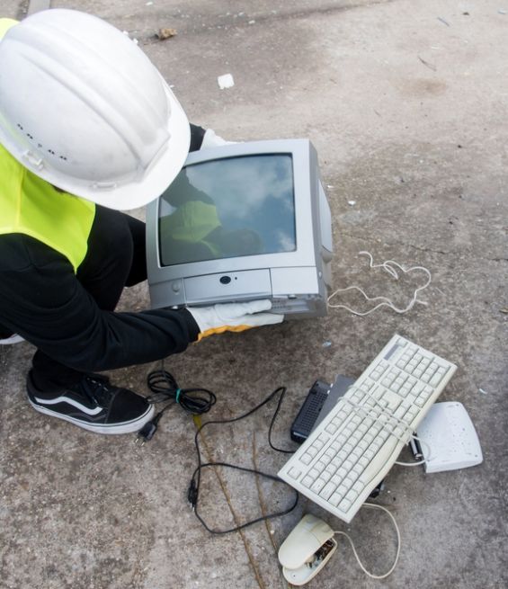 Recycling,Center,Worker,Collecting,An,Old,Tube,Television,And,Other