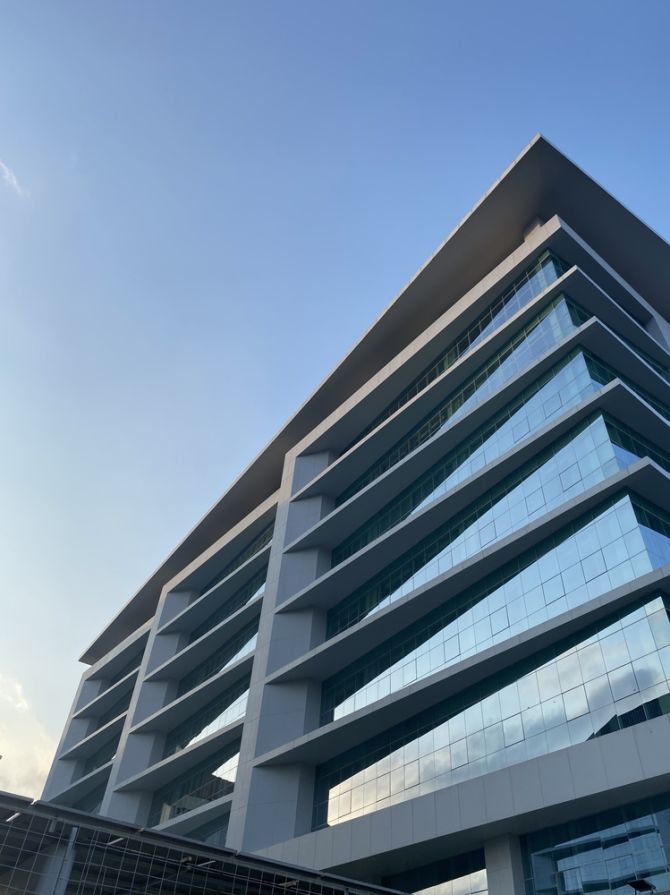 Contemporary,High-rise,Building,Captured,From,Below,,Showcasing,Sleek,Lines,,Mirrored